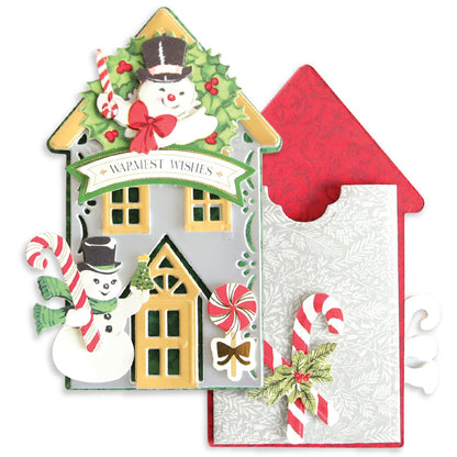 a christmas card with a house and candy canes.