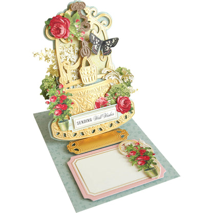 A Wishing Well Easel Finishing School Kit with flowers and a note.
