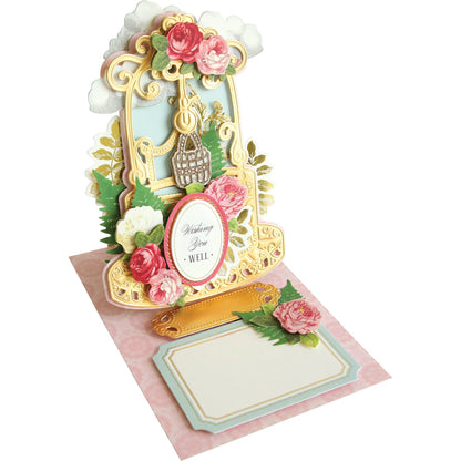 A Wishing Well Easel Finishing School Kit with flowers on it.