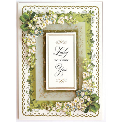 a card with a picture frame and flowers on it.