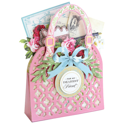 a pink card holder with flowers and a blue ribbon.