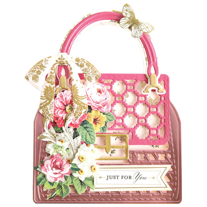 a pink purse with flowers and butterflies on it.