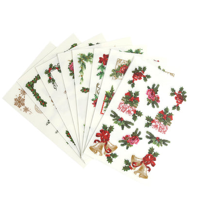 A set of Christmas Ephemera Rub Ons with holly leaves and bows.