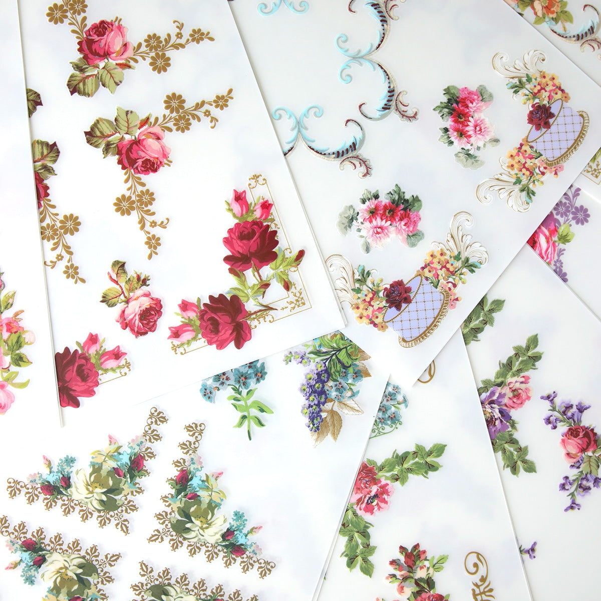 A bunch of Birthday Ephemera Rub Ons with floral designs on them.