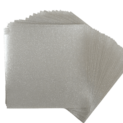 a stack of silver glitter paper on a white background.