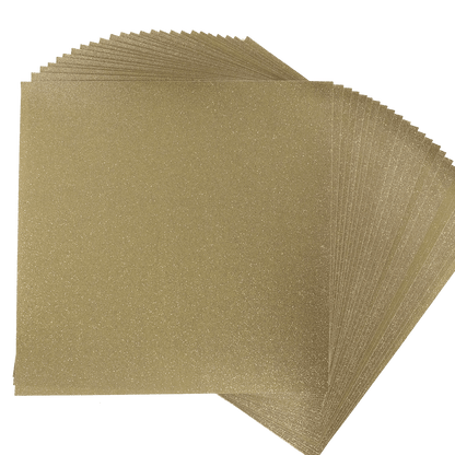 a stack of gold glitter paper on a white background.
