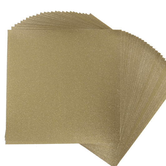 a stack of gold glitter paper on a white background.