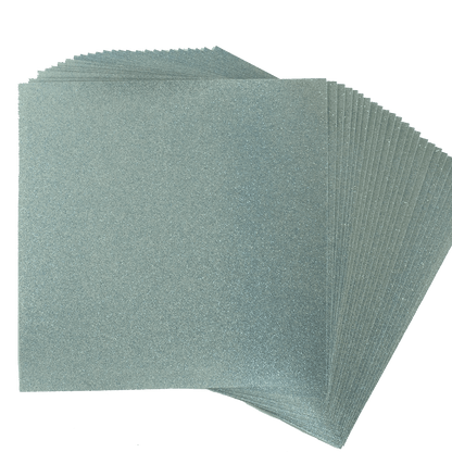 a stack of silver colored paper on a white background.