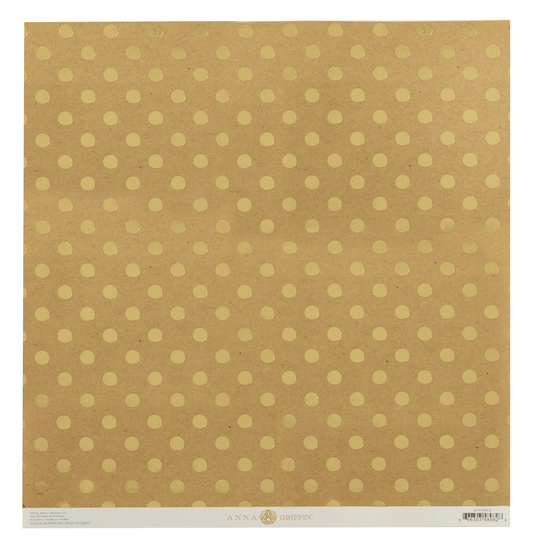 a piece of brown paper with gold polka dots on it.