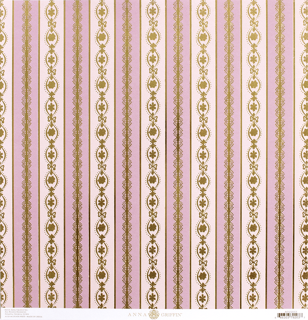 a pink and gold striped wallpaper with gold designs.