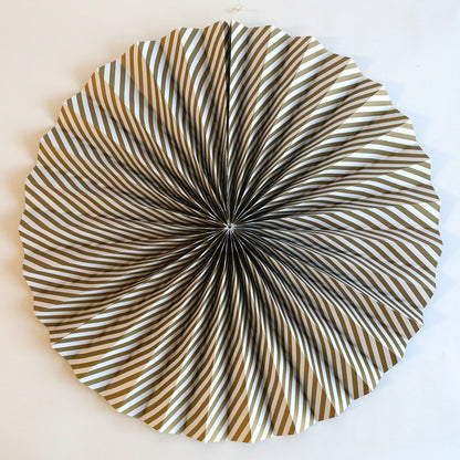 a circular metal object on a white wall.