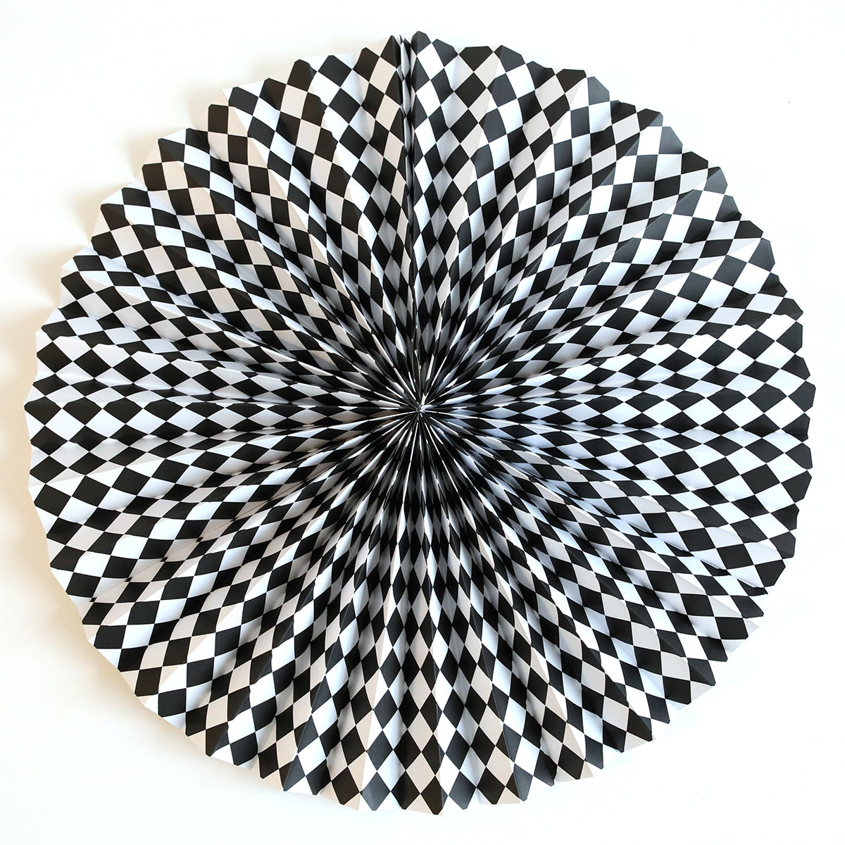 a black and white checkered pattern on a white wall.