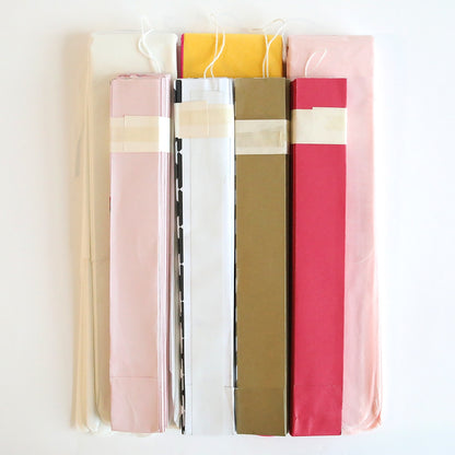 a row of different colored books on a white wall.
