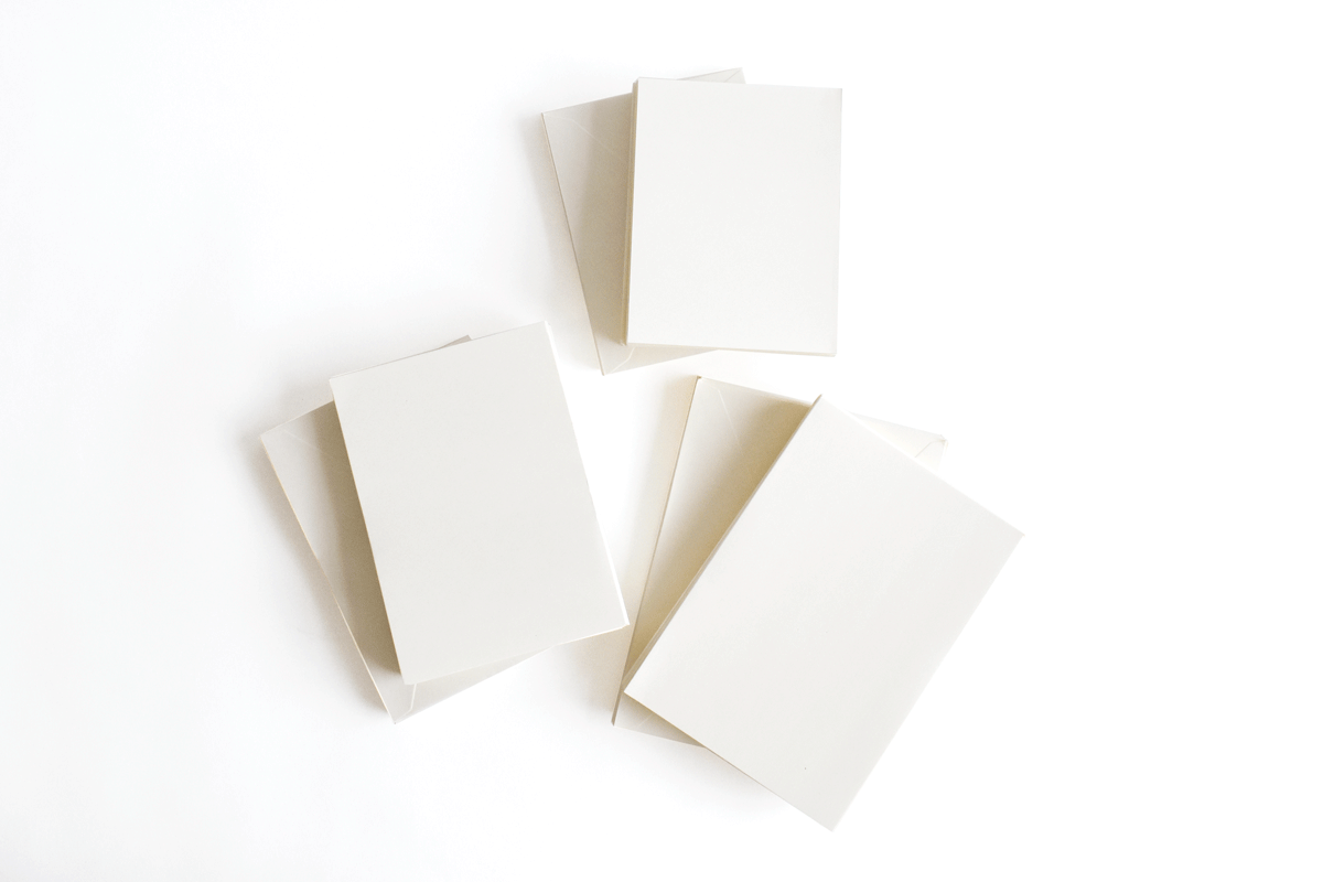 a group of four blank cards sitting on top of each other.