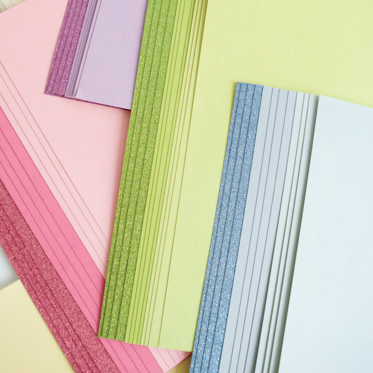 a pile of different colored papers sitting on top of each other.