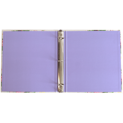 a purple binder with a pen on top of it.