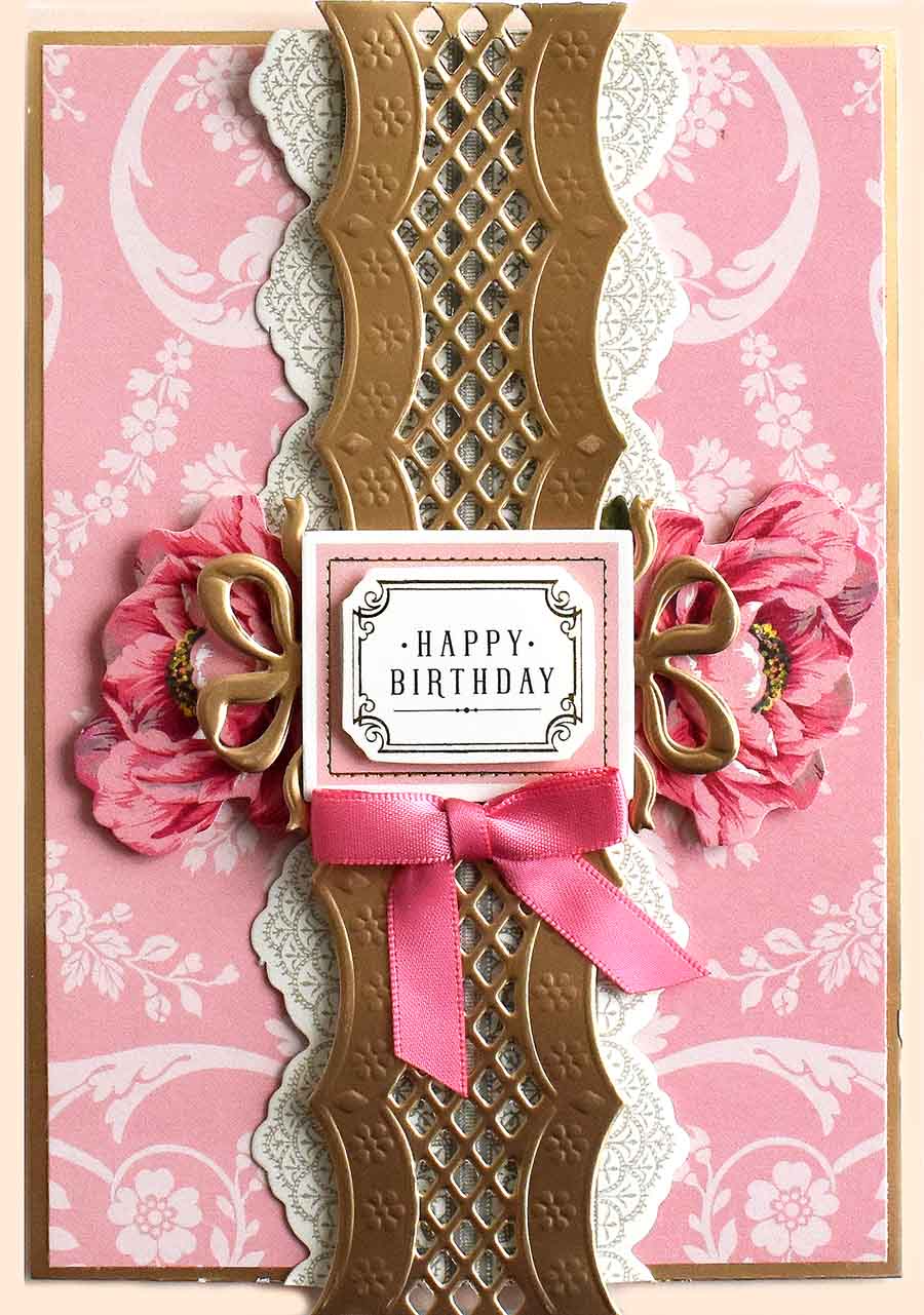 a pink and gold birthday card with a pink ribbon.