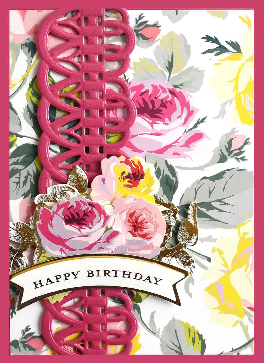 a birthday card with pink flowers and a ribbon.