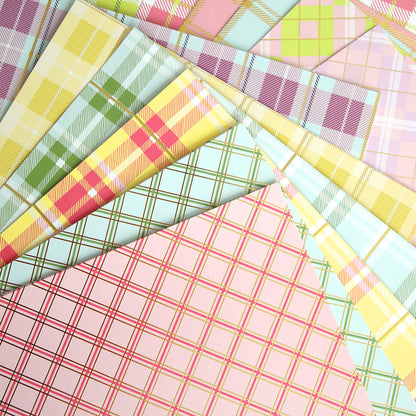 a pile of colorful plaid paper on top of each other.
