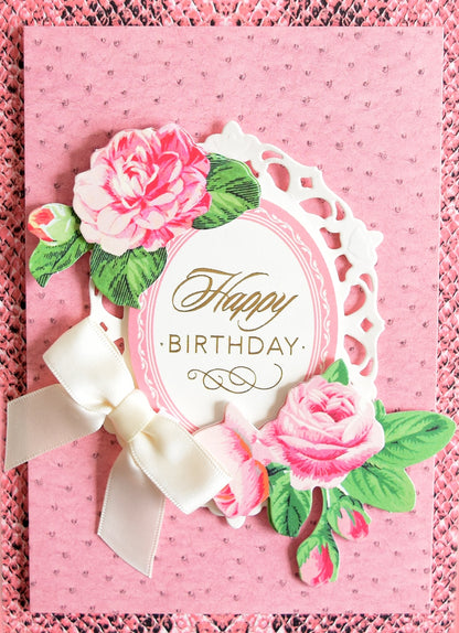 a birthday card with pink roses and a white bow.
