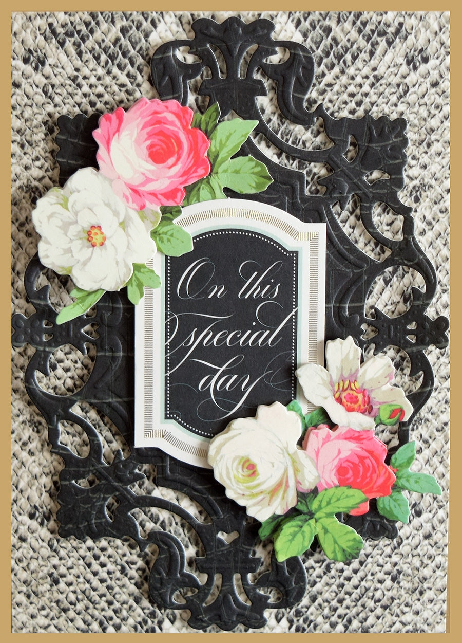 a black and white card with pink and white flowers.