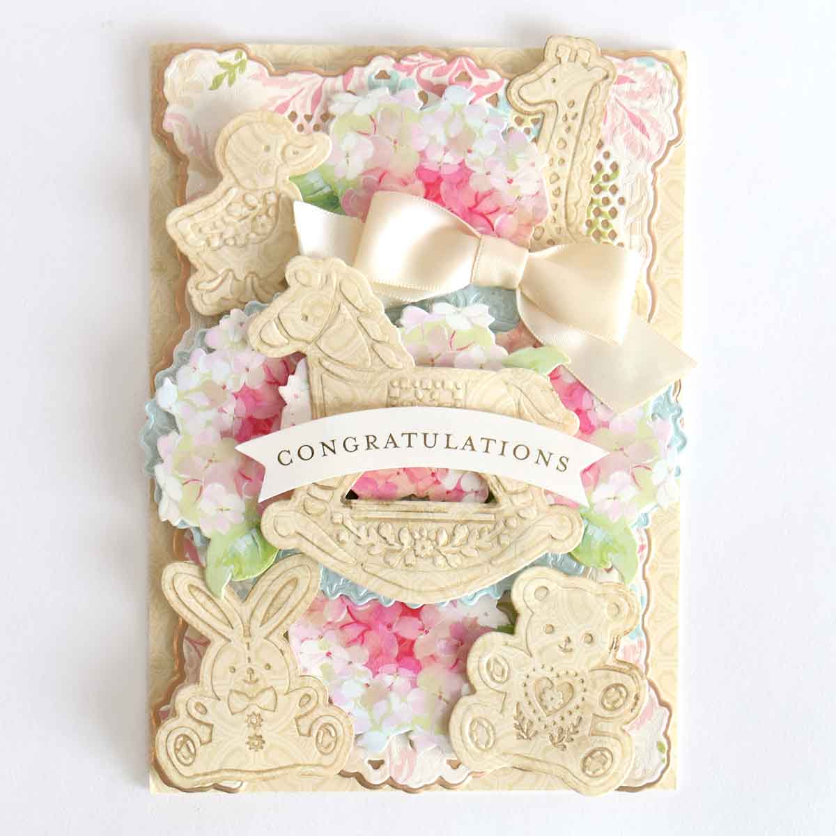 a congratulations card with flowers and a bow.