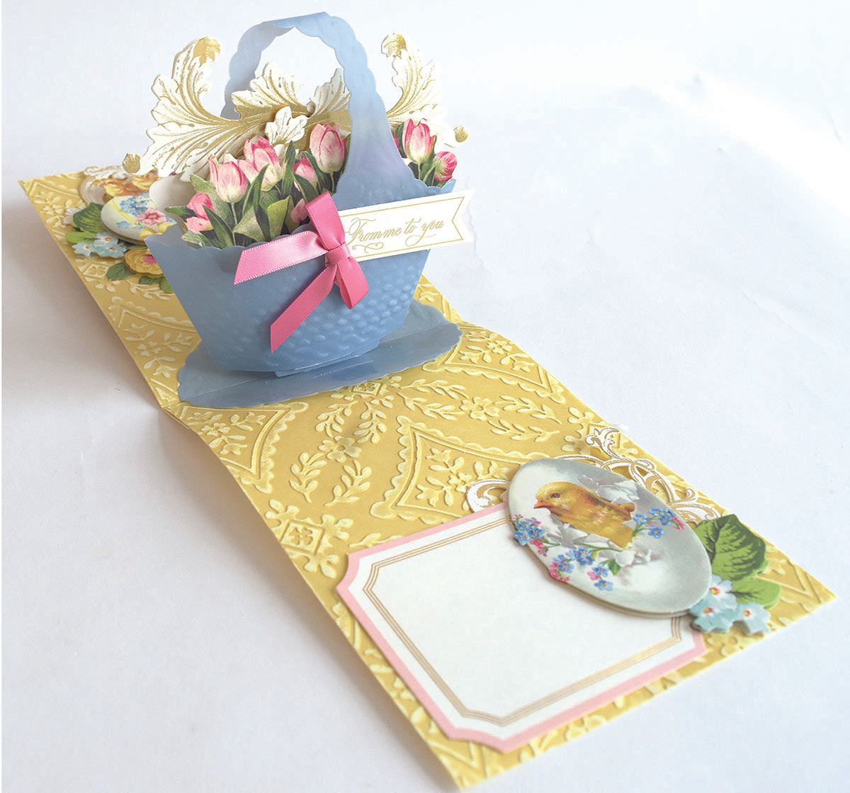 a blue bag with a pink bow on top of a table.