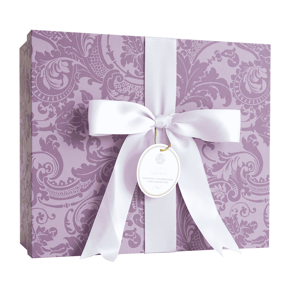 a purple gift box with a white ribbon and a tag.