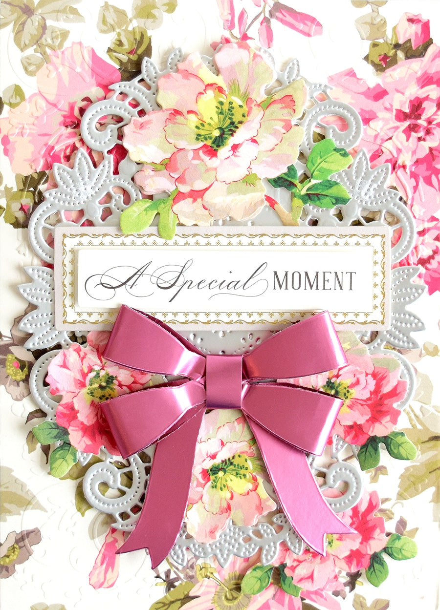 a close up of a card with a pink bow.