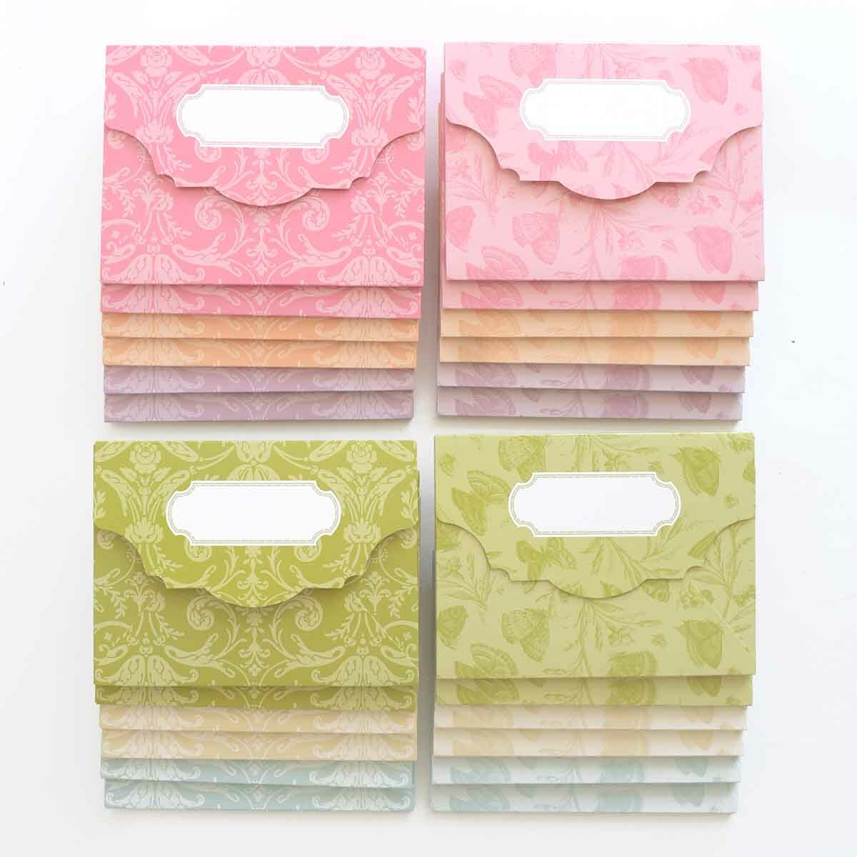 a set of four pink, green, and yellow paper bags.