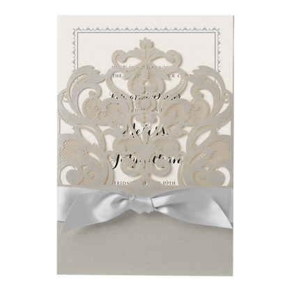 a white wedding card with a silver bow.