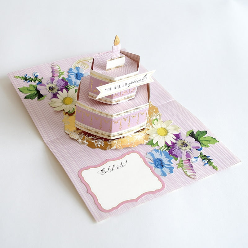 a card with a birthday cake on top of it.
