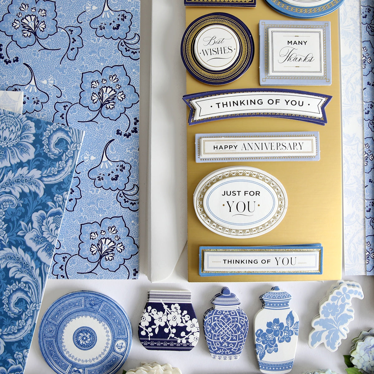 a table topped with blue and white plates and vases.