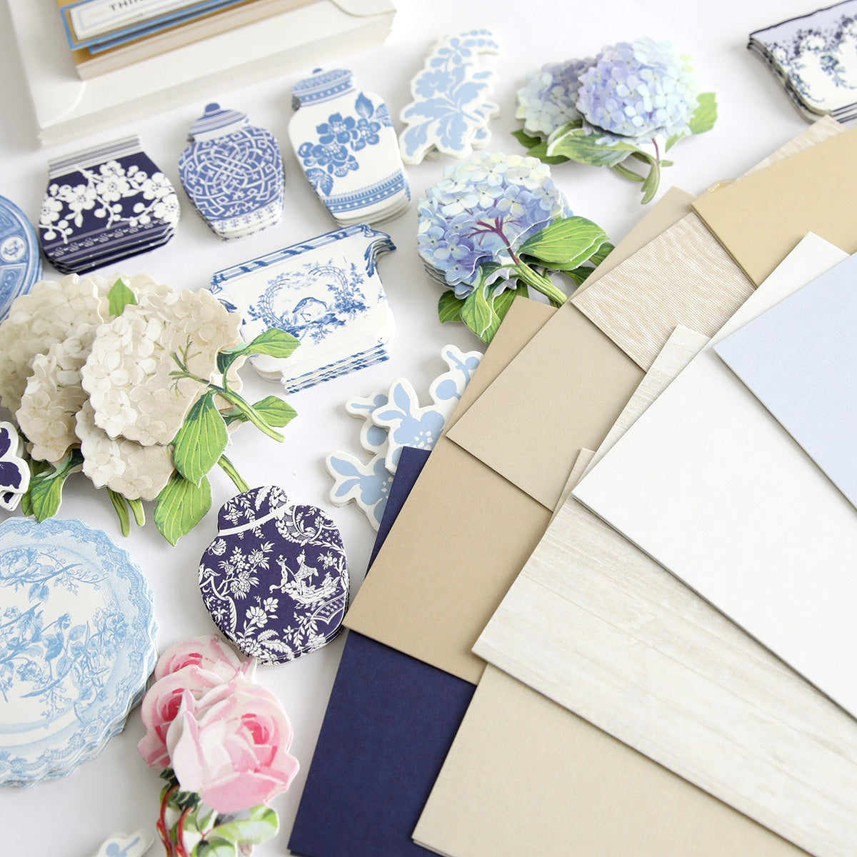 a table topped with blue and white plates and flowers.