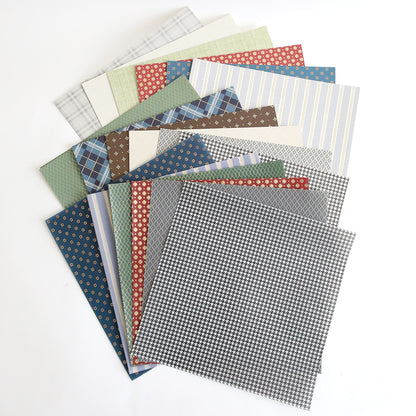 A pile of Carte Homme Cardstock and Vellum in different colors sitting on top of each other.