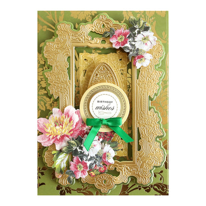 a picture frame decorated with flowers and a green ribbon.