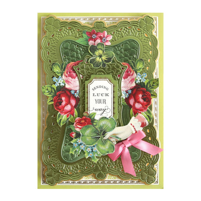 a green card with flowers and a pink ribbon.