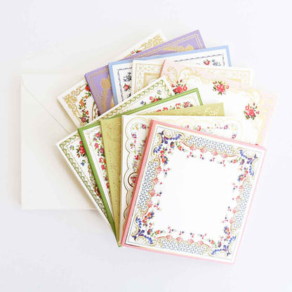 a pile of cards with a white envelope.