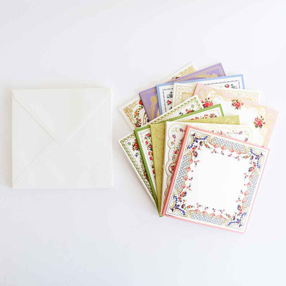 a white envelope with six different colored cards.