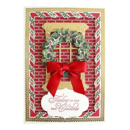 a christmas card with a red ribbon and a wreath.