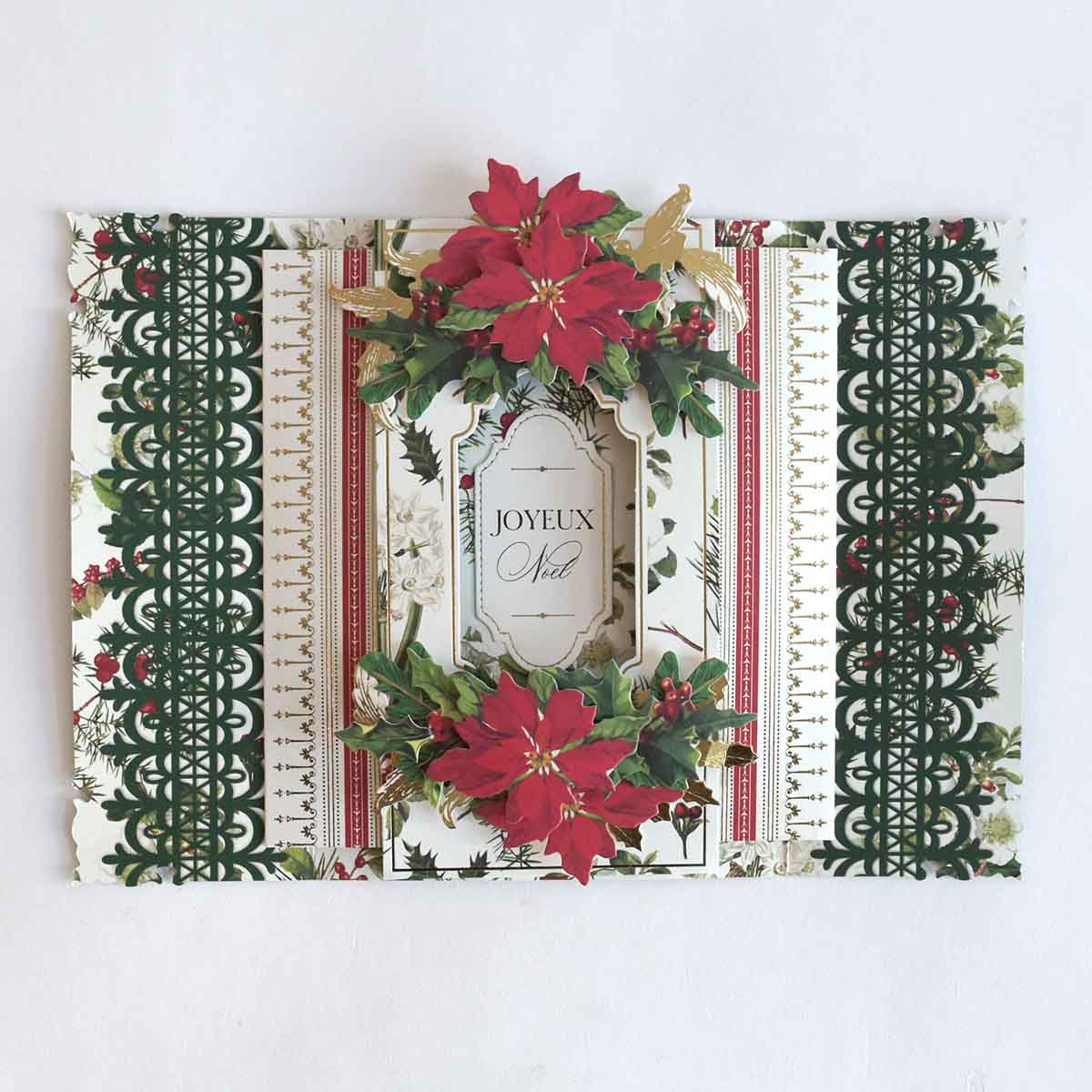 a christmas card with poinsettis and ribbons.