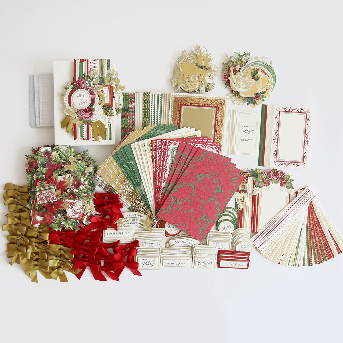 A Christmas Wishes Card Making Kit, papers, and ribbons.