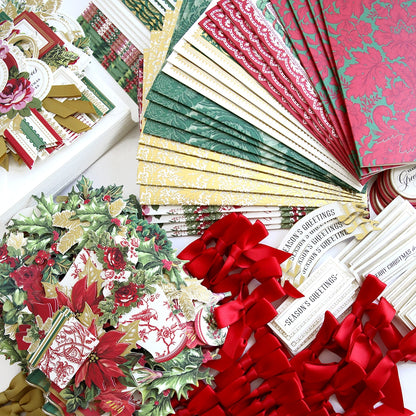 A collection of Christmas Wishes Card Making Kit papers and ribbons on a table.