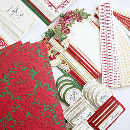 A collection of Christmas Wishes Card Making Kits and papers on a white surface.