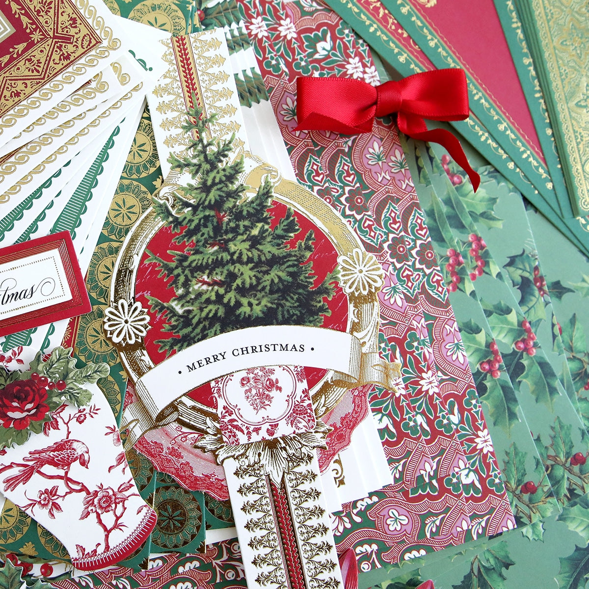A collection of Christmas Wishes Card Making Kit with red and green ribbons.