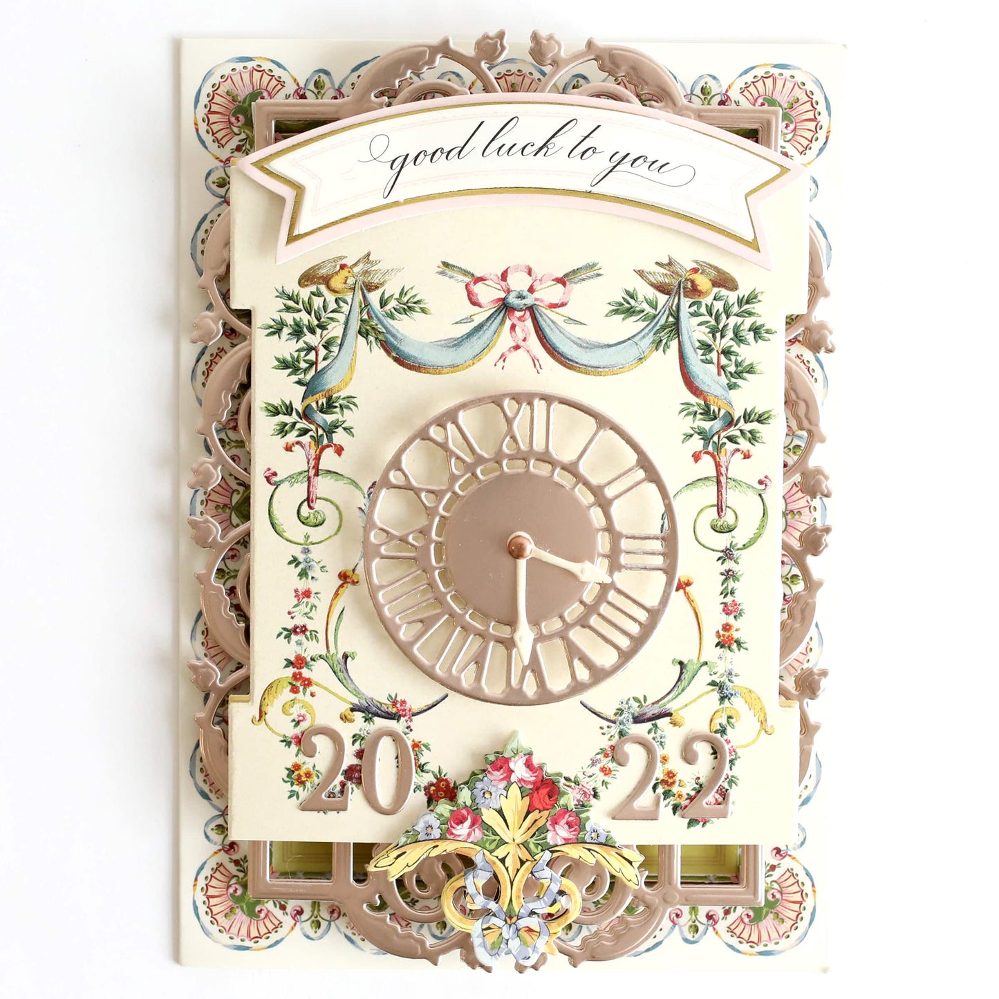 a white clock with a floral design on it.