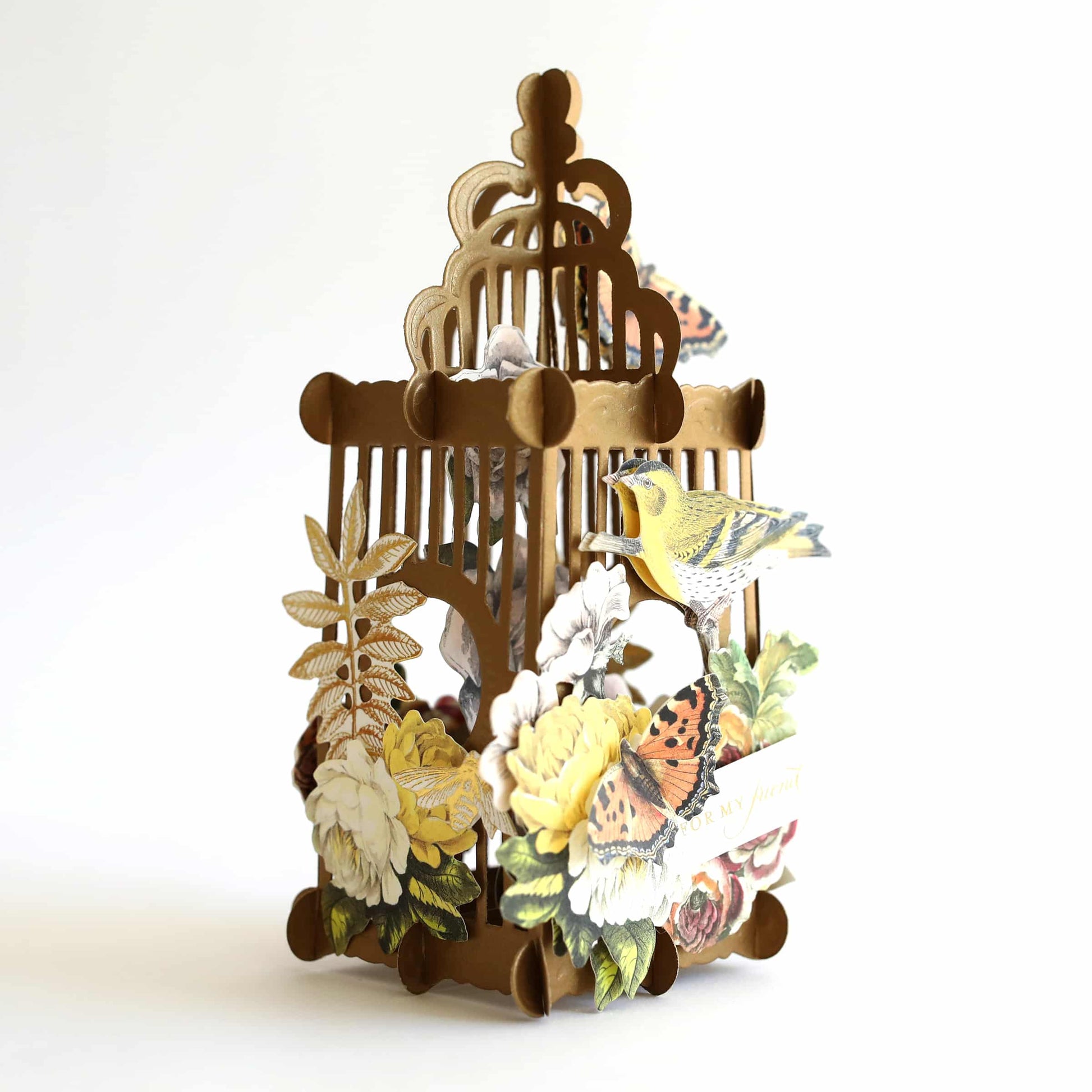 a birdcage with a bunch of flowers on it.