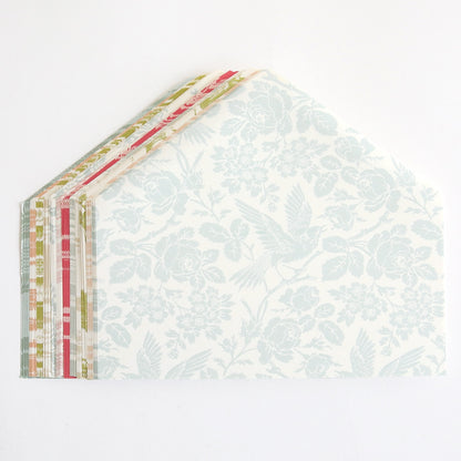 A stack of Damask Envelope Liners with a floral pattern on them.