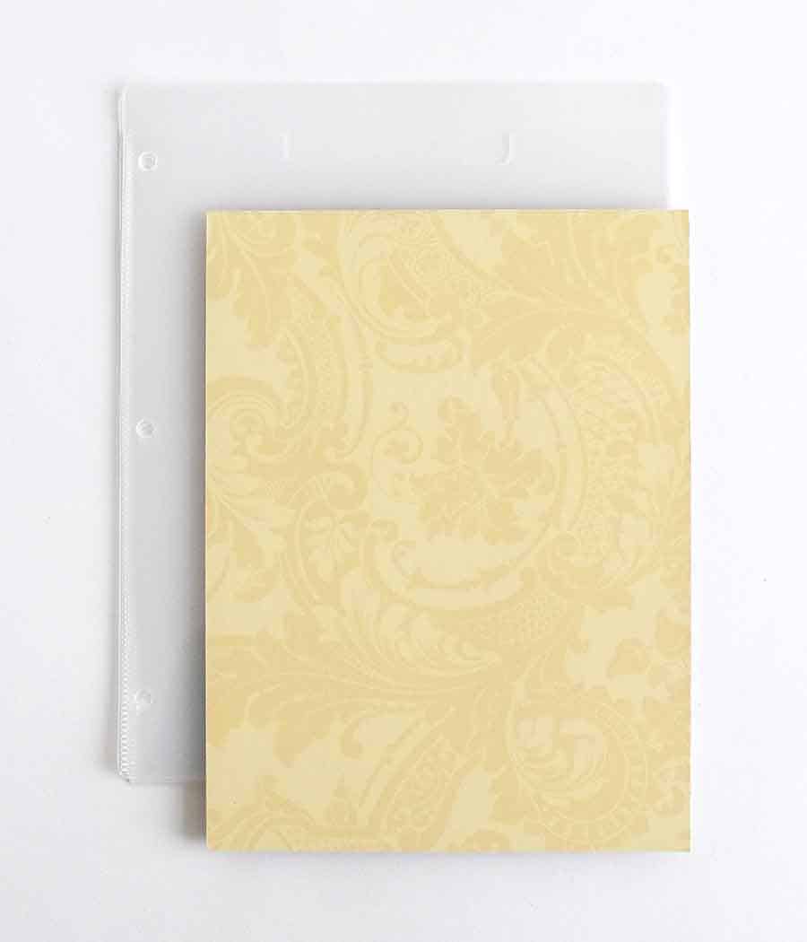 a yellow notebook with a white pen on top of it.