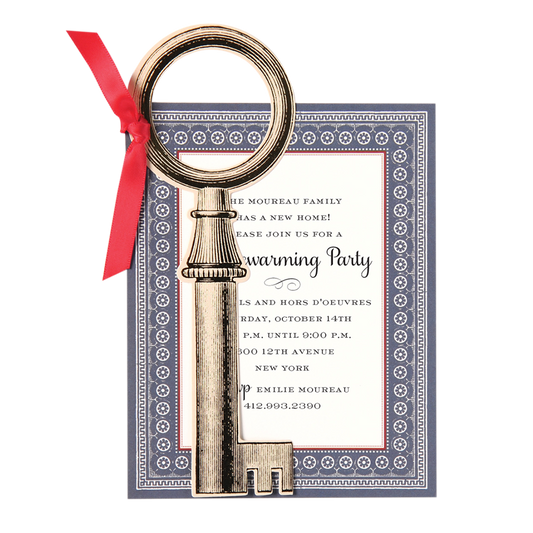 a silver key with a red ribbon around it.